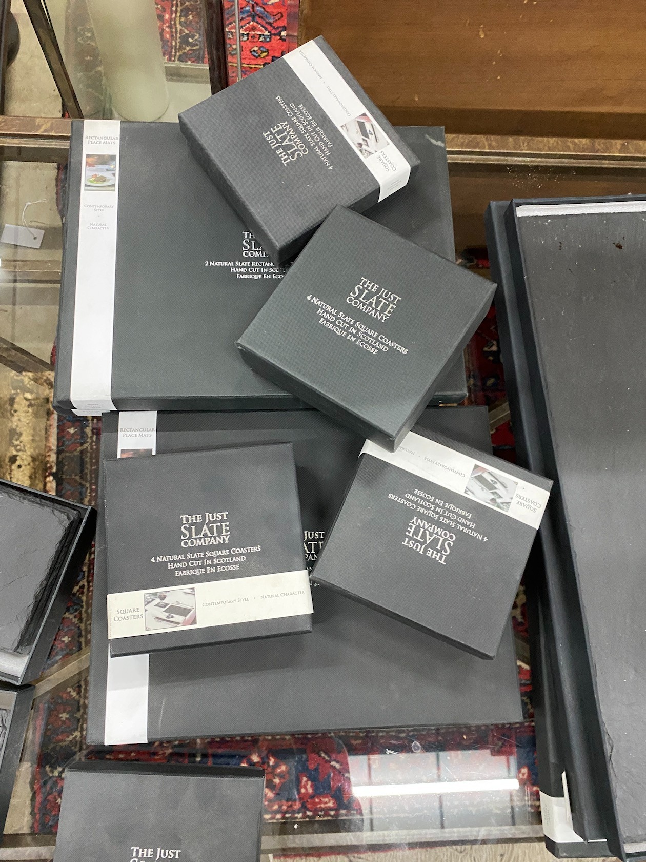 A quantity of 'The Just Slate Company' table mats, runners and coasters, all boxed